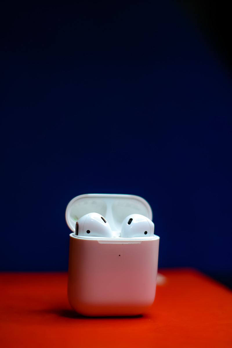 A White Apple Airpods on a Pink Case